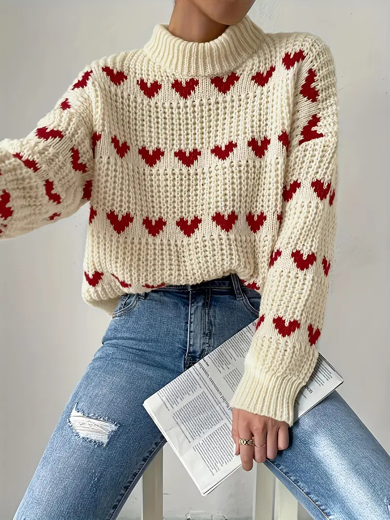 Naomi trui met hartpatroon – een warme en speelse essential voor de gezellige seizoenen. Met een textured breisel, knusse turtleneck en relaxte pasvorm biedt deze trui comfort en stijl. Perfect voor casual dagen, gezellige avonden of als speelse toevoeging aan je garderobe. Combineer moeiteloos met jeans, leggings of rokken. Verkrijgbaar in beige, maten S-L. Voeg charme en warmte toe aan je outfit met de Naomi. Bestel nu!