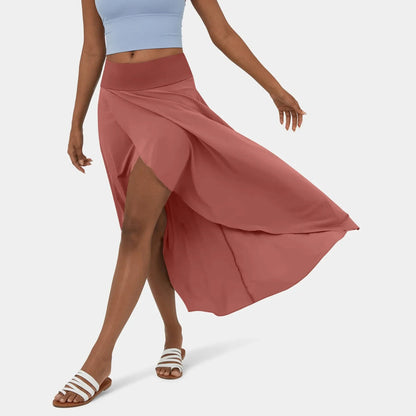 Libra | Elegante Gespleten Maxi Rok - Voeg stijl en comfort toe aan je garderobe met de Libra maxi rok. Ideaal voor elk seizoen dankzij het high-low ontwerp, ruches voor extra volume, en een elegante maxi-lengte. Perfect voor kantoor, avondjes uit of casual dagen. Gemaakt van duurzaam polyester in diverse kleuren: Khaki, Oranje, Roze, Blauw, Vermiljoen en Wijn. Verkrijgbaar in maten XS-XL. Upgrade je looks met deze tijdloze must-have!